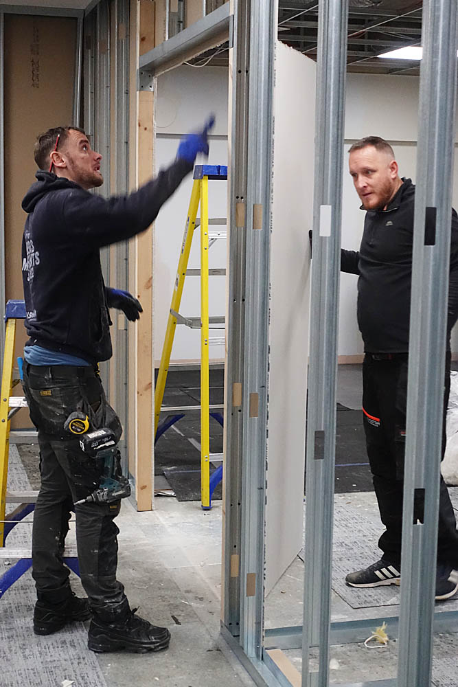 Brad and Kev creating the aperture for the lounge to changing area feature double doors