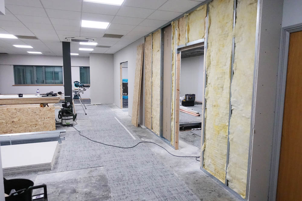 looking from the main entrance, both apertures in one shot: the lounge to staffroom foreground; the lounge to changing area somewhere in the distance