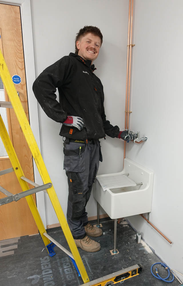 Angus, standing Kitchener-like, next to his latest conquest - the cleaner's sink