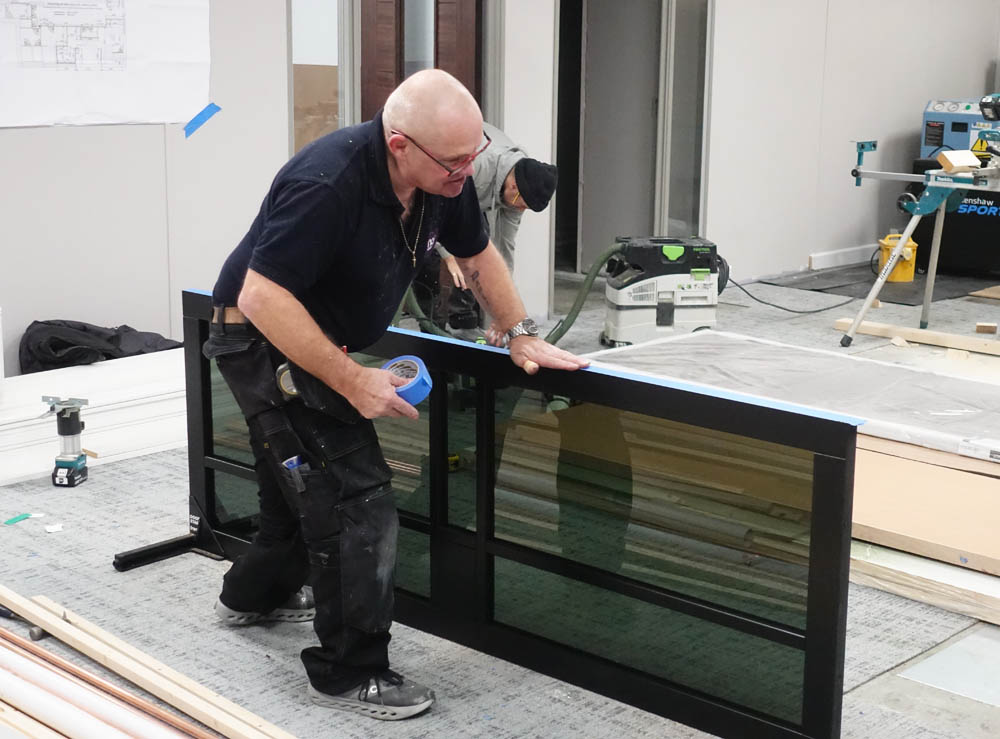Neal tending to the wonderful doors that will lead from the lounge to the changing area