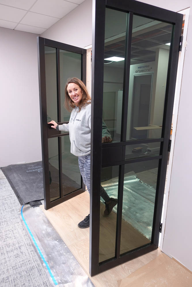 Emma emerging from the changing areas as she tries out the new doors
