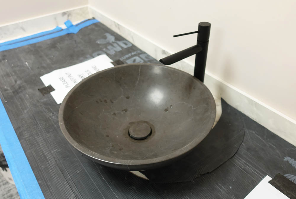 The marble sink on the vanity unit has been baptised - you can see the water drops