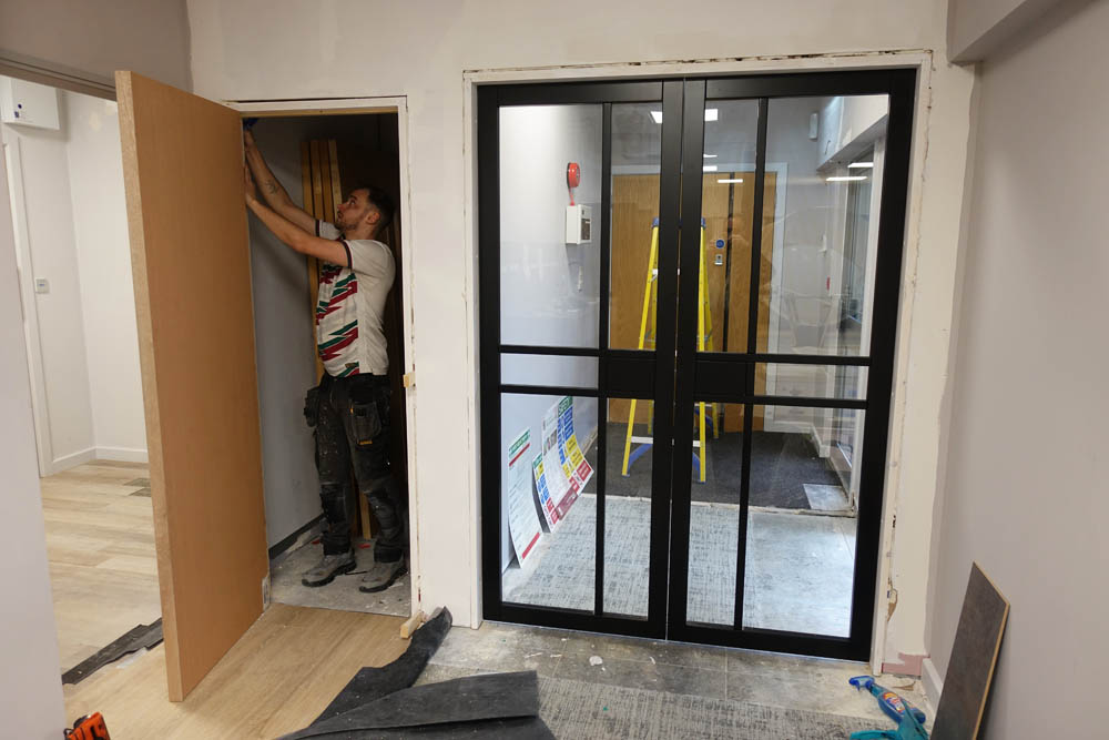 Brad is working on the secret door to the cleaner's cupboard with the main doors on the right