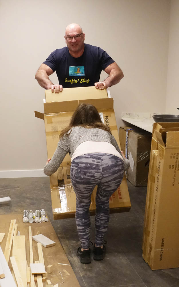 Emma and Neil demonstrating impeccable technique during the unboxing of a mirror