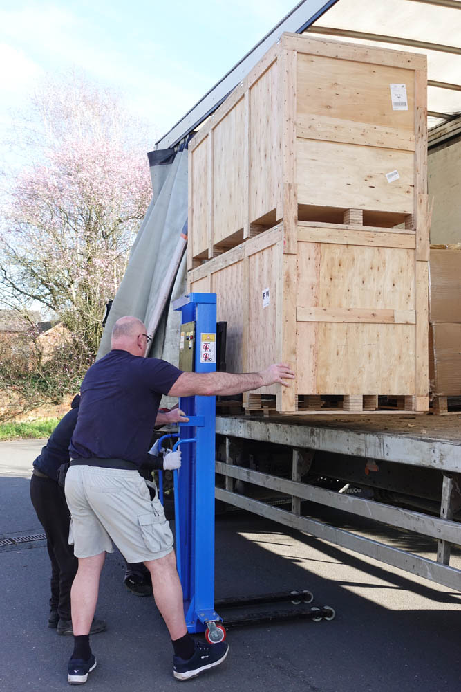 The great unloading of the two red light beds that have come hot-foot directly from China