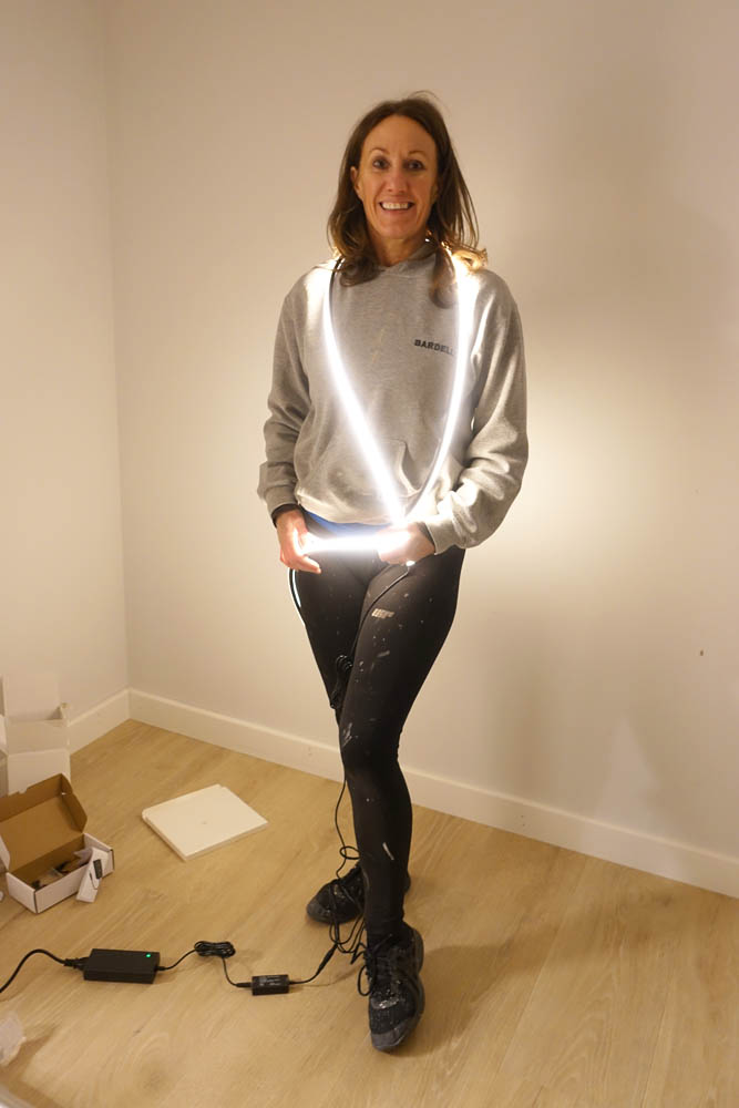Emma trying on the lights that after she's paraded herself down Broad Street in them, are destined for the acoustic panels