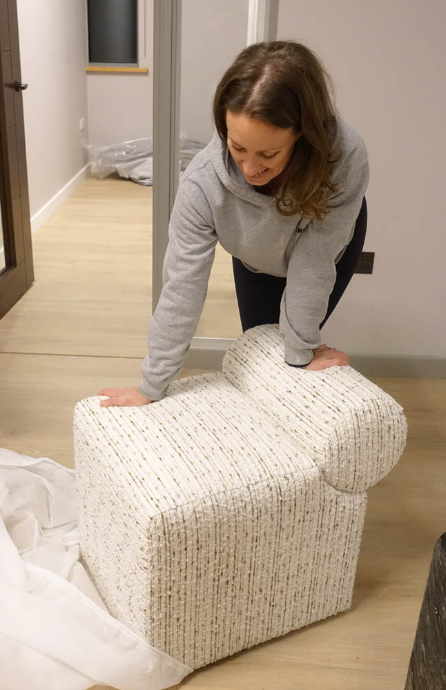 Emma trying a LECCO foot stool in Gloria Natural
