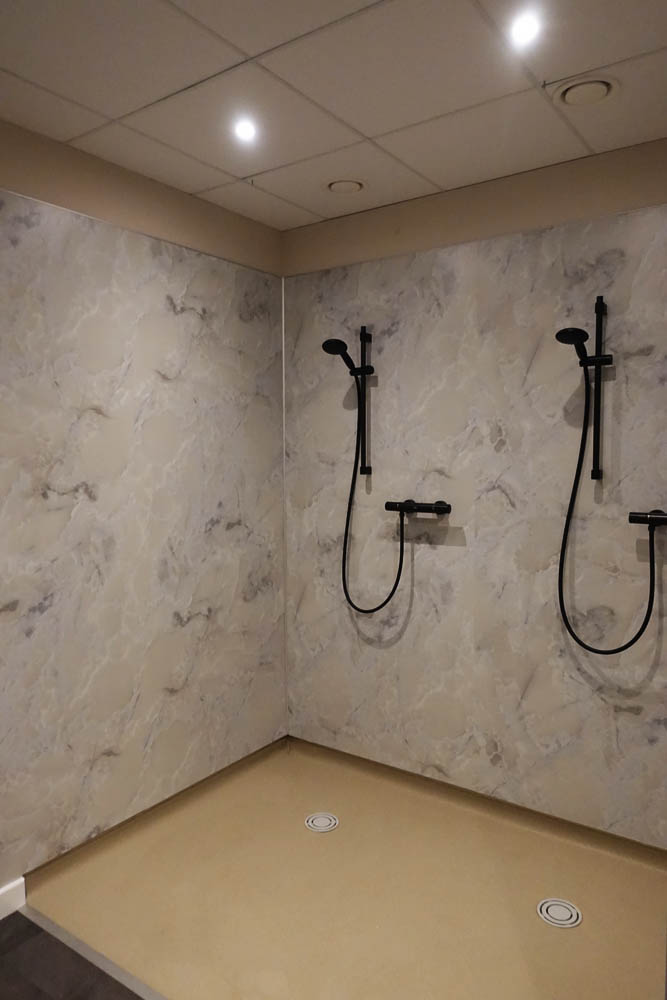 All that now needs to happen is the installation of the bespoke, sand-blasted shower doors and divides