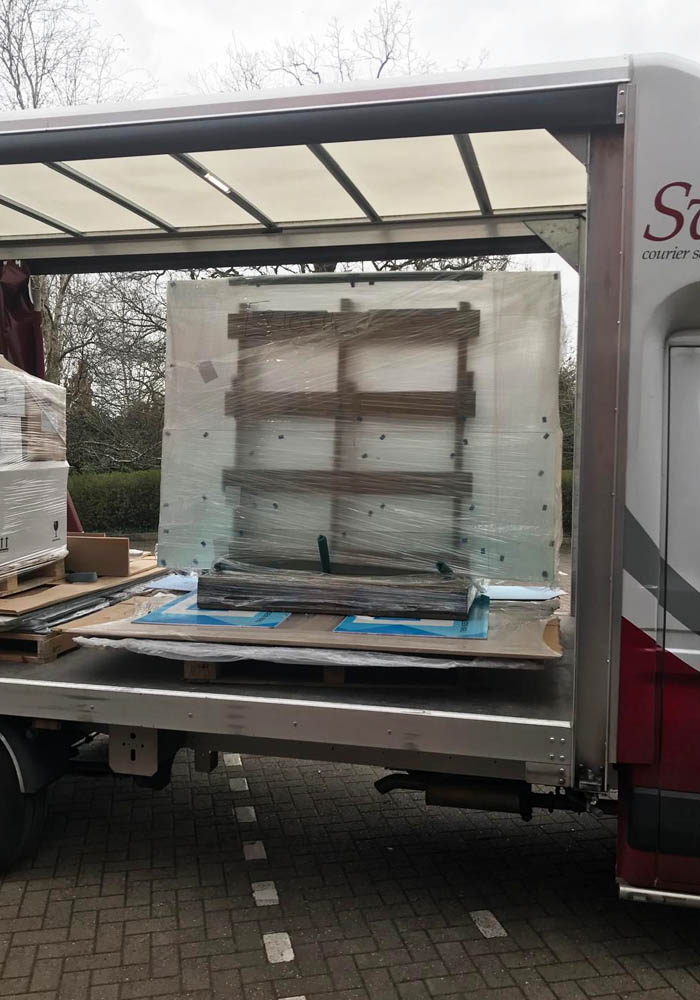The sand-blasted glass shower panels arrive